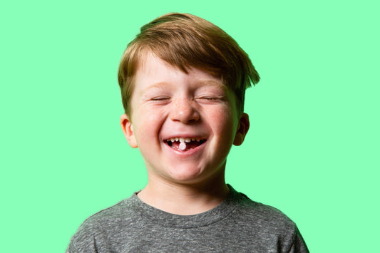 Avery with a Canary Watermelon Kid-friendly Toothpaste Tablet between his teeth