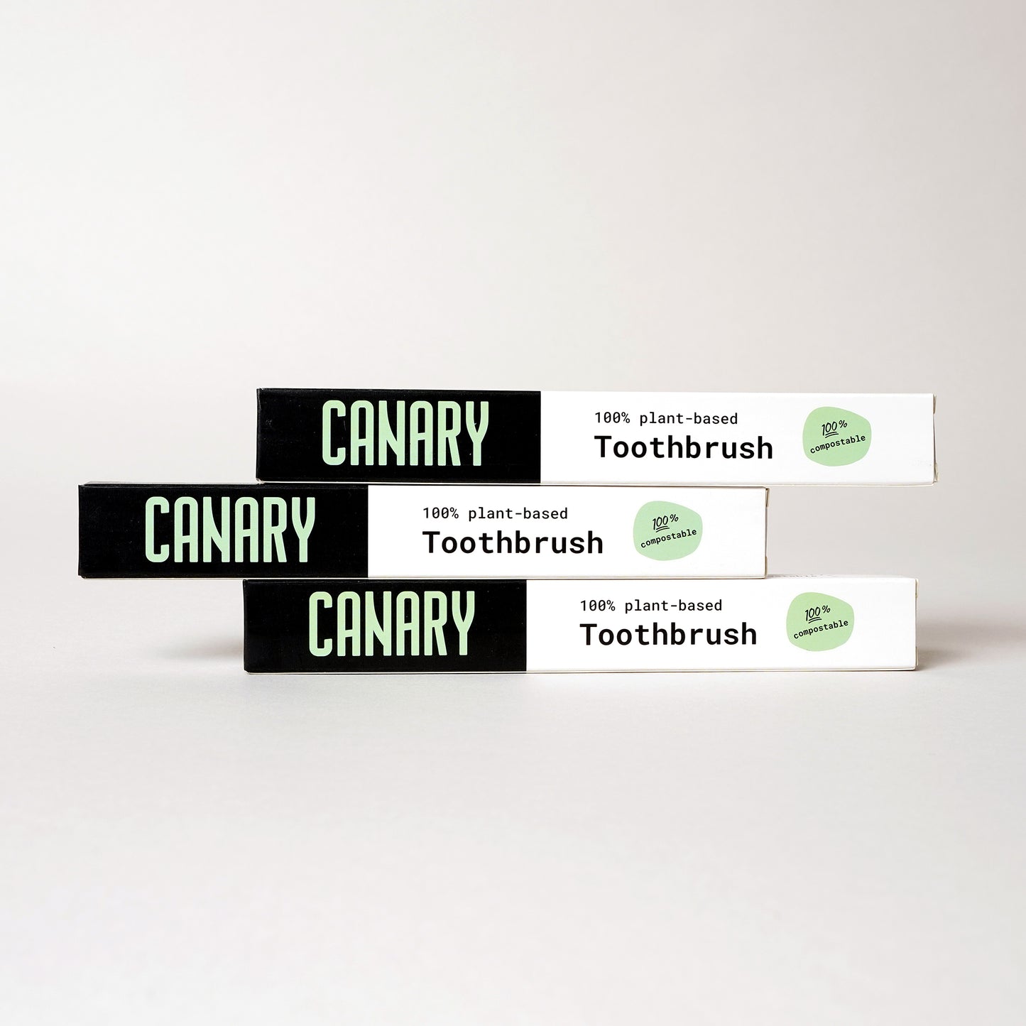 3-Pack of Canary plant-based and fully compostable bamboo toothbrushes stack on each other.