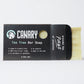 Canary Tea Tree Bar Soap partially out of the plastic-free packaging