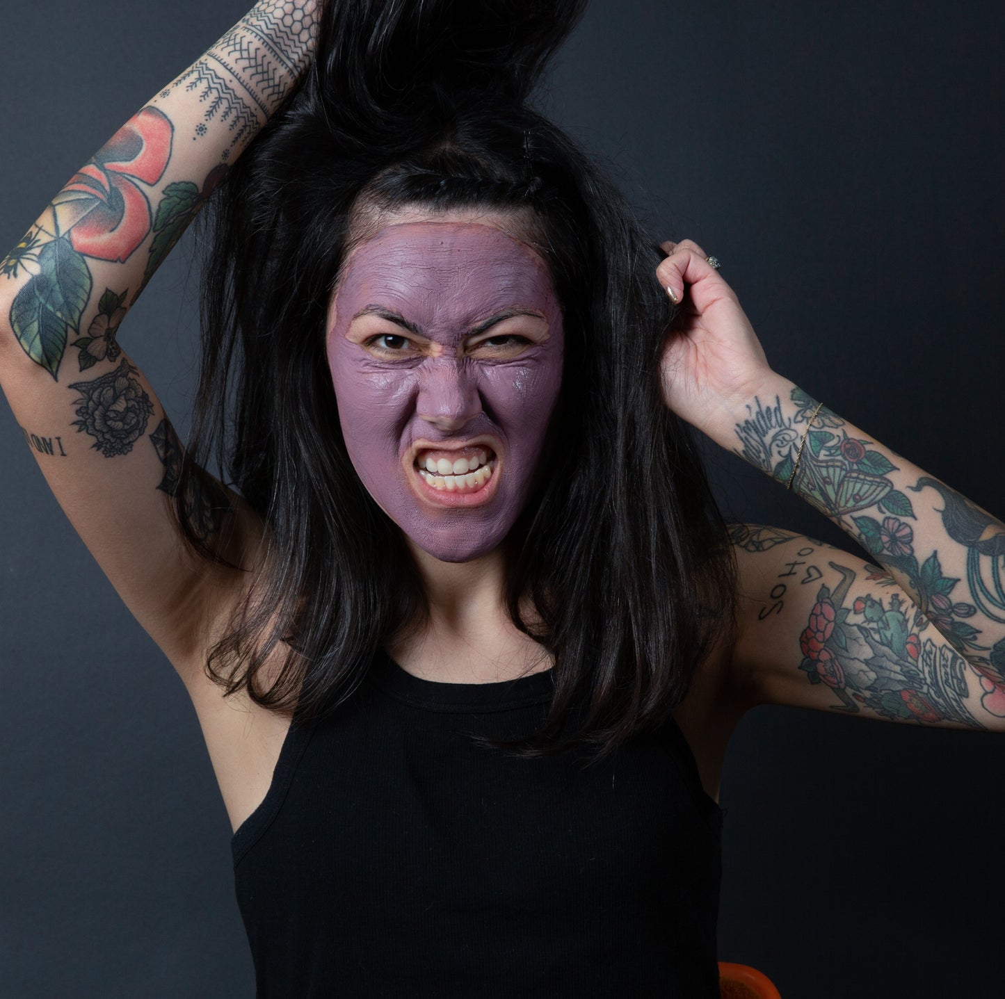Woman making silly face using Bentonite Clay + Rose Face Mask