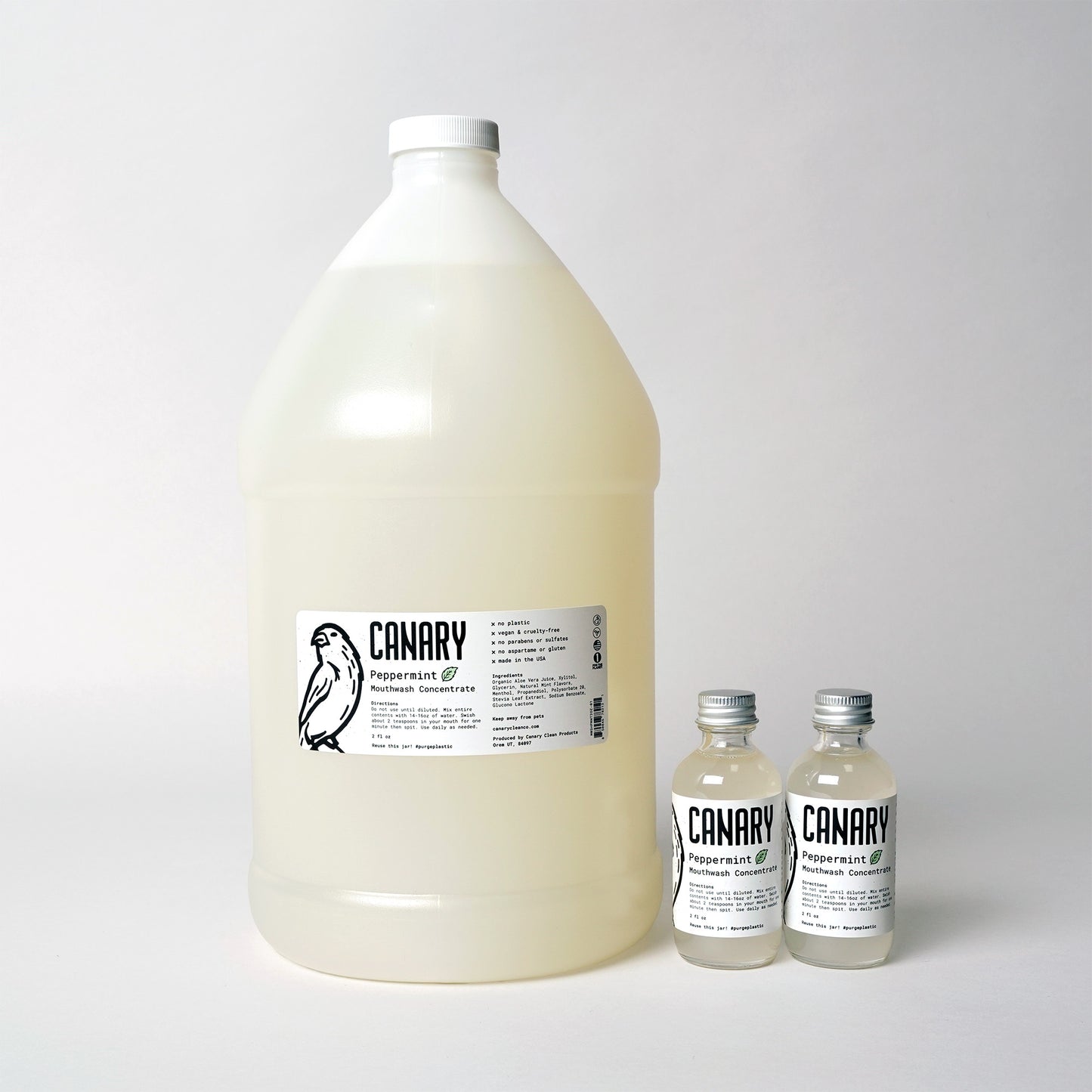 One Gallon of bulk concentrated Peppermint Flavored Mouthwash, for wholesale, retail and refill shops. Shown next to two of our 2oz bottles for size reference.