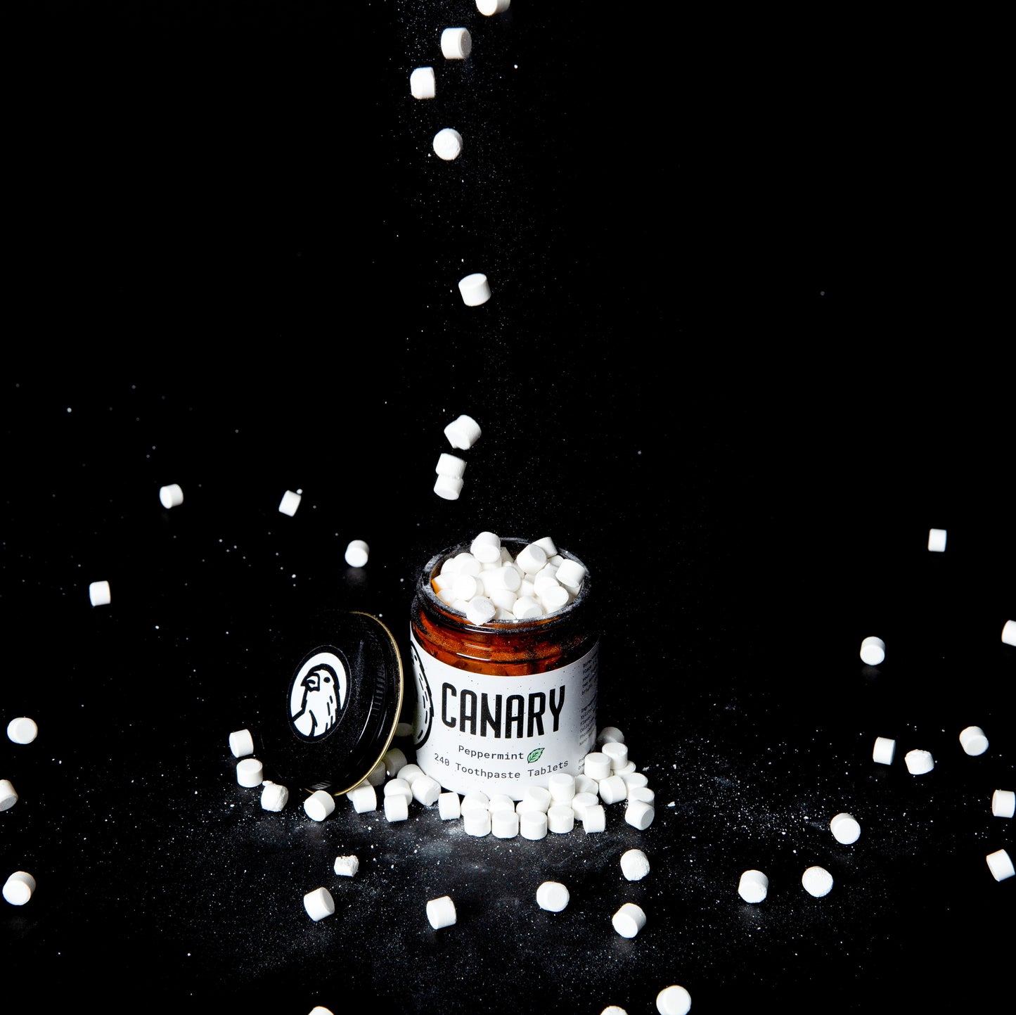 Canary Toothpaste Tablets falling from the sky into the refillable jar