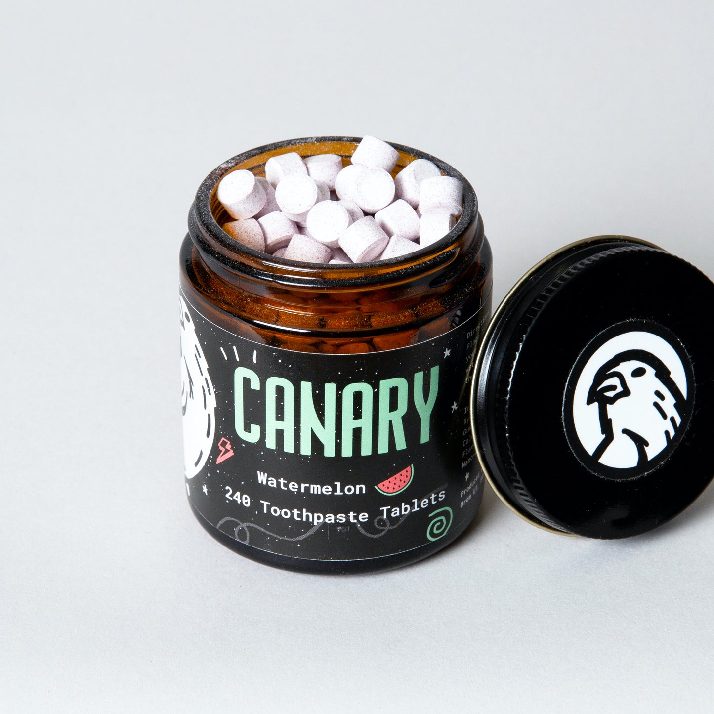 Canary Watermelon Toothpaste Tablets, 240 count jar, view from top peeking into jar at tablets