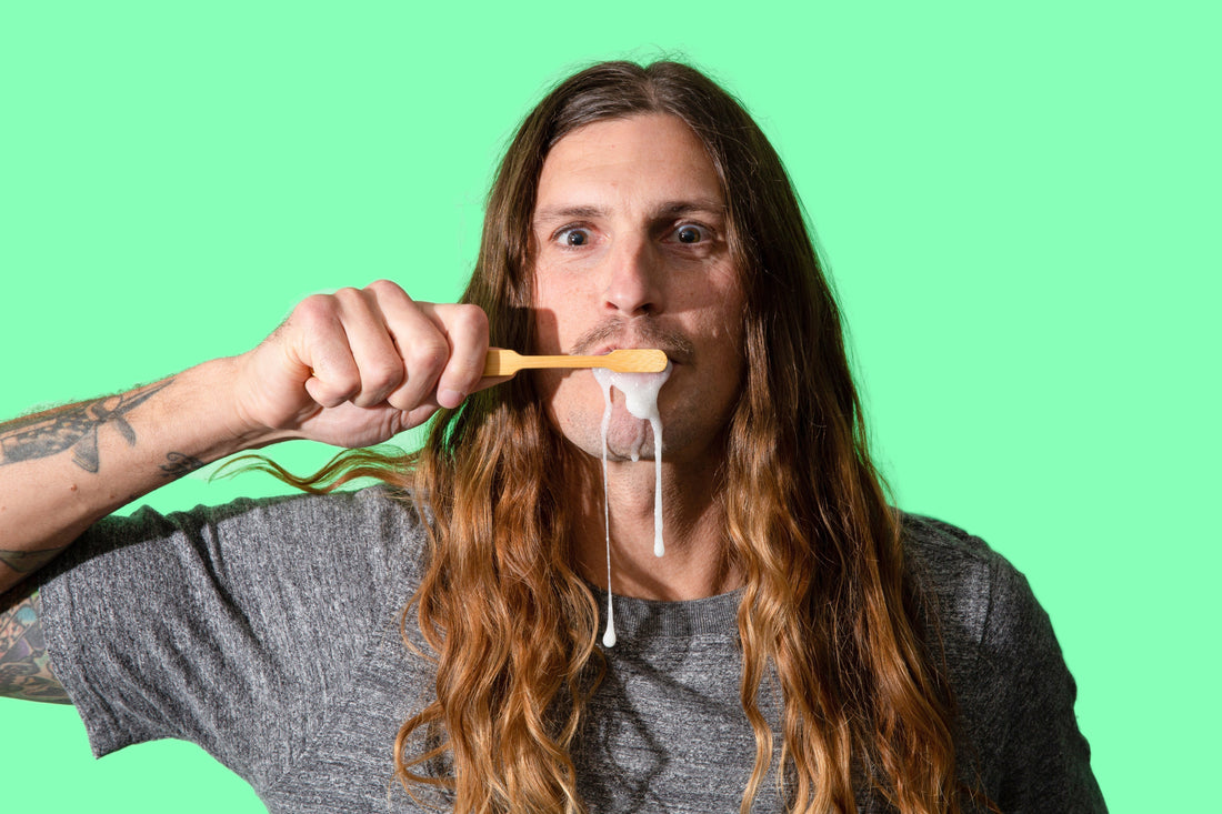 Man brushing teeth with toothpaste tablet