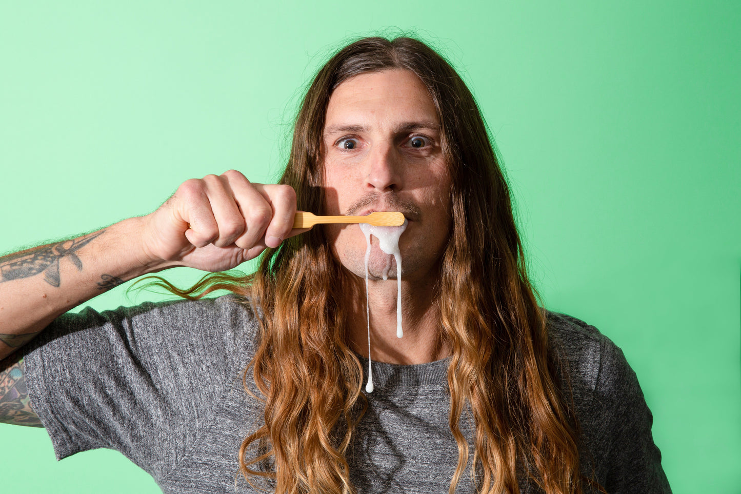 Kevin brushing with Canary Peppermint Toothpaste Tablets, with foam dripping down his chin