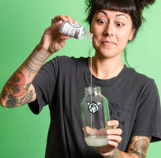 Image of Woman using the canary peppermint mouthwash concentrate