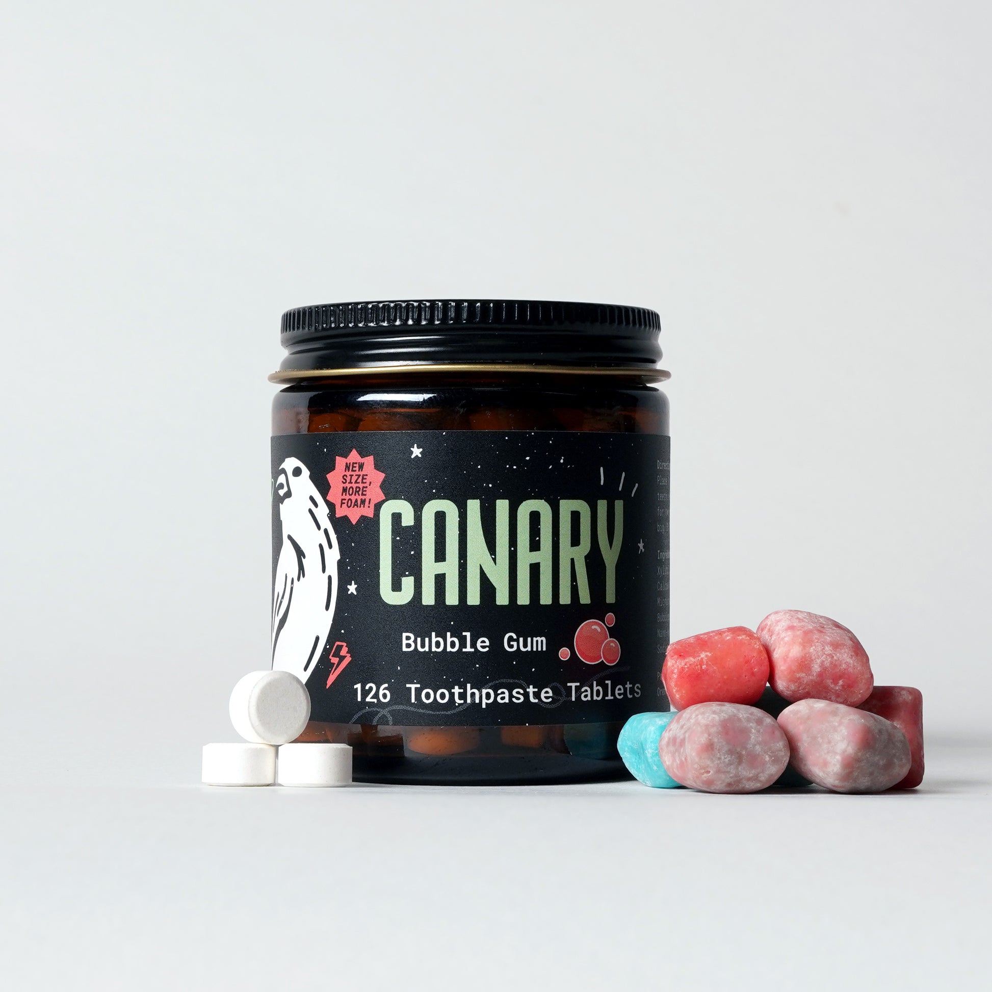 Front Image of Bubble Gum Flavored Toothpaste Tablets. Front of the reusable glass jar with toothpaste tablets and bubble gum outside. 126-count tablets. 