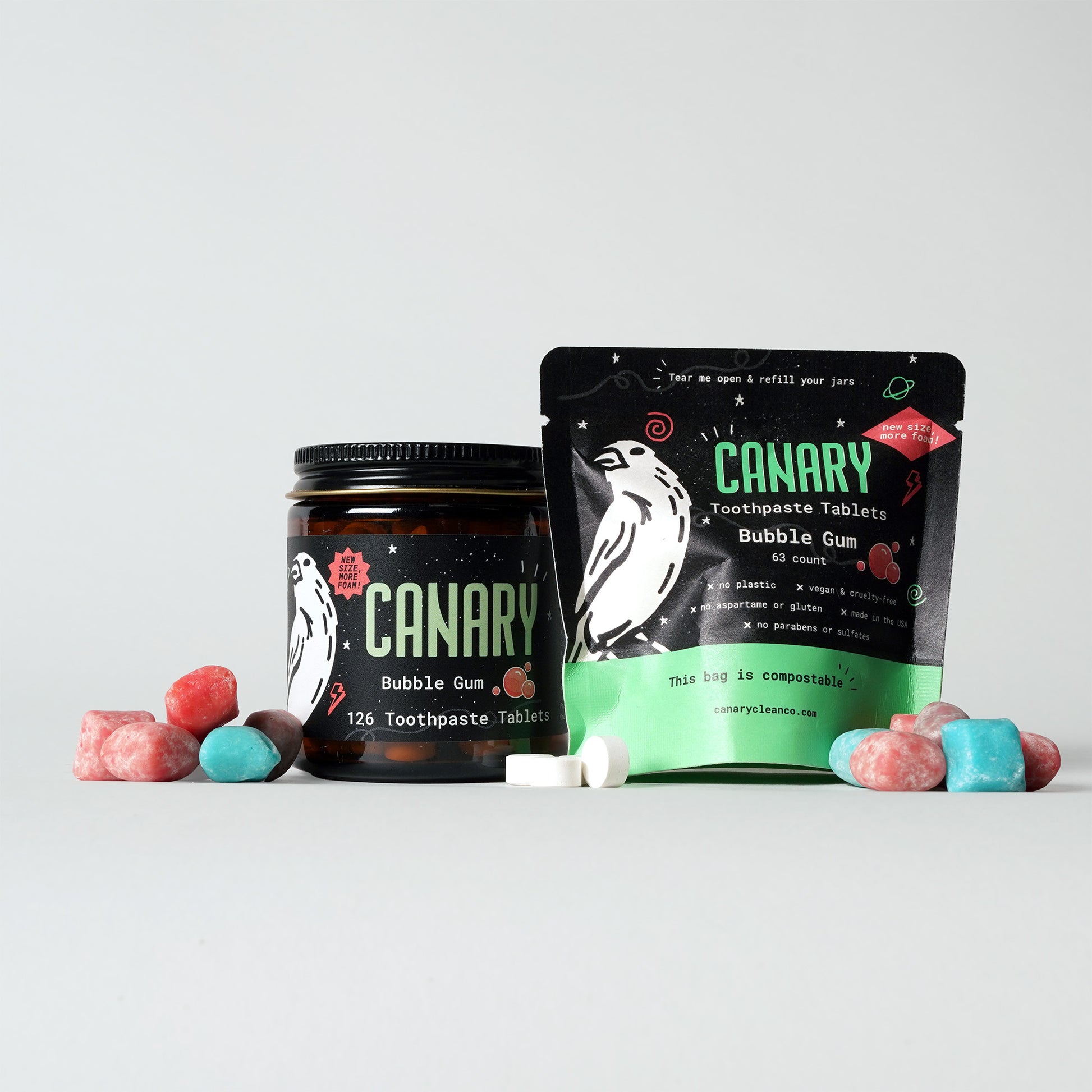 Front Image of Bubble Gum Flavored Toothpaste Tablets. Reusable glass jar of 126 tablets. And 63-count Plastic-Free and Compostable Pouch. Surrounded by bubble gum and toothpaste tablets. 