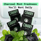 Canary Dental Floss with bathroom background with charcoal and mint in the foreground. 