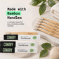 Close up image of canary plant based bamboo toothbrush on bathroom sink with packaging and plants surrounding the product.