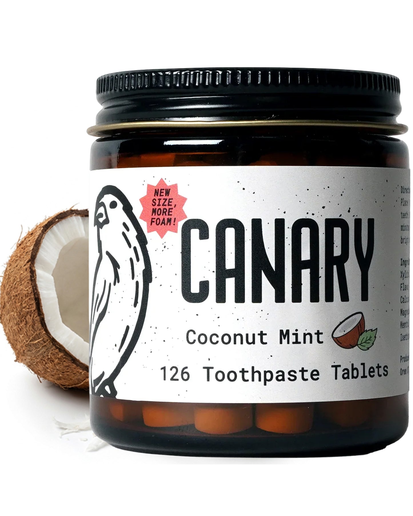 Close Up Image of Canary Coconut Mint Toothpaste tablets jar - 126 count. With a coconut in the background of image.