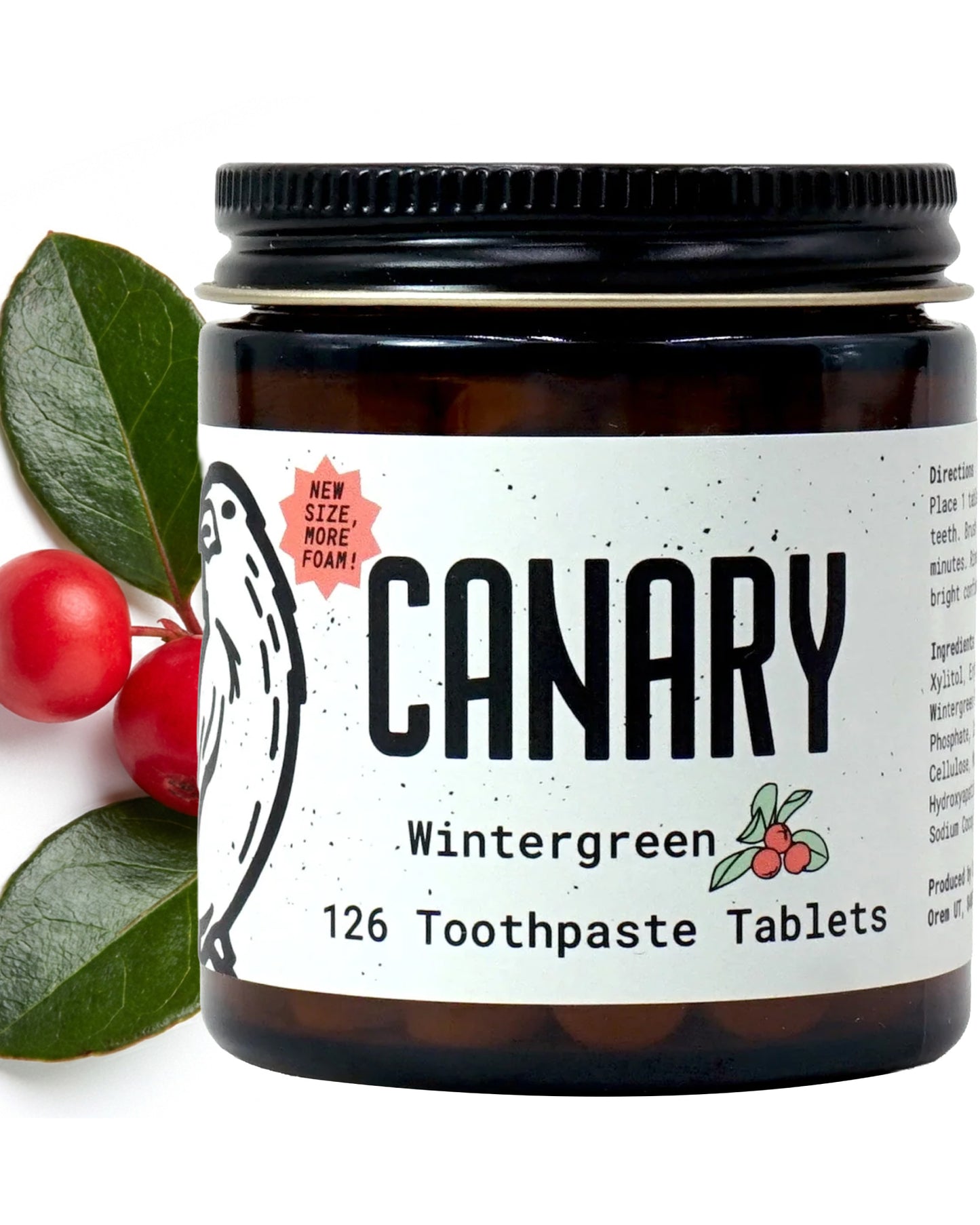 Close Up Image of Canary Wintergreen Toothpaste tablets jar - 126 count. With wintergreen leaves in the background