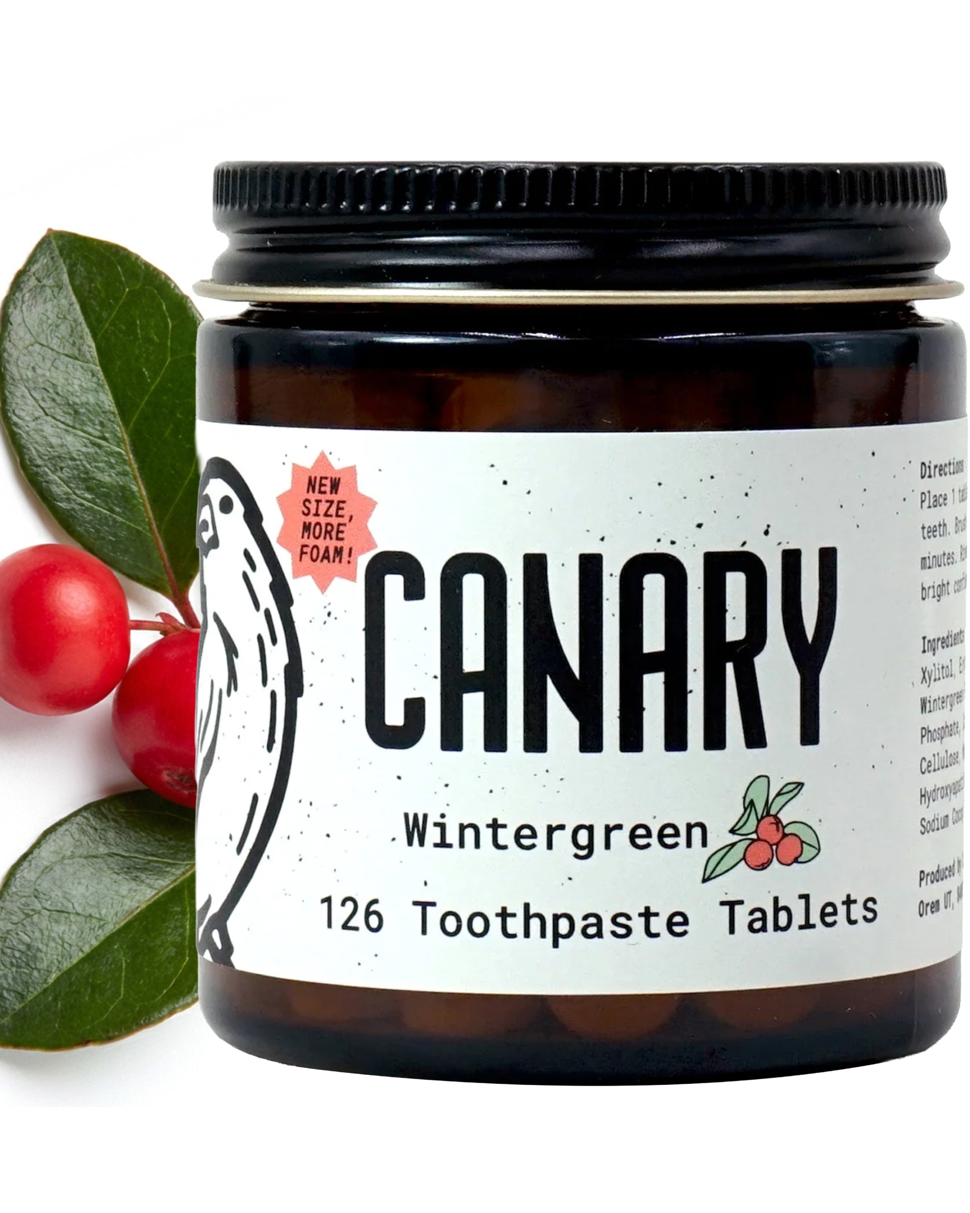 Close Up Image of Canary Wintergreen Toothpaste tablets jar - 126 count. With wintergreen leaves in the background