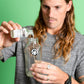 Kevin pouring Canary Peppermint Mouthwash Concentrate into a reusable glass mixing bottle