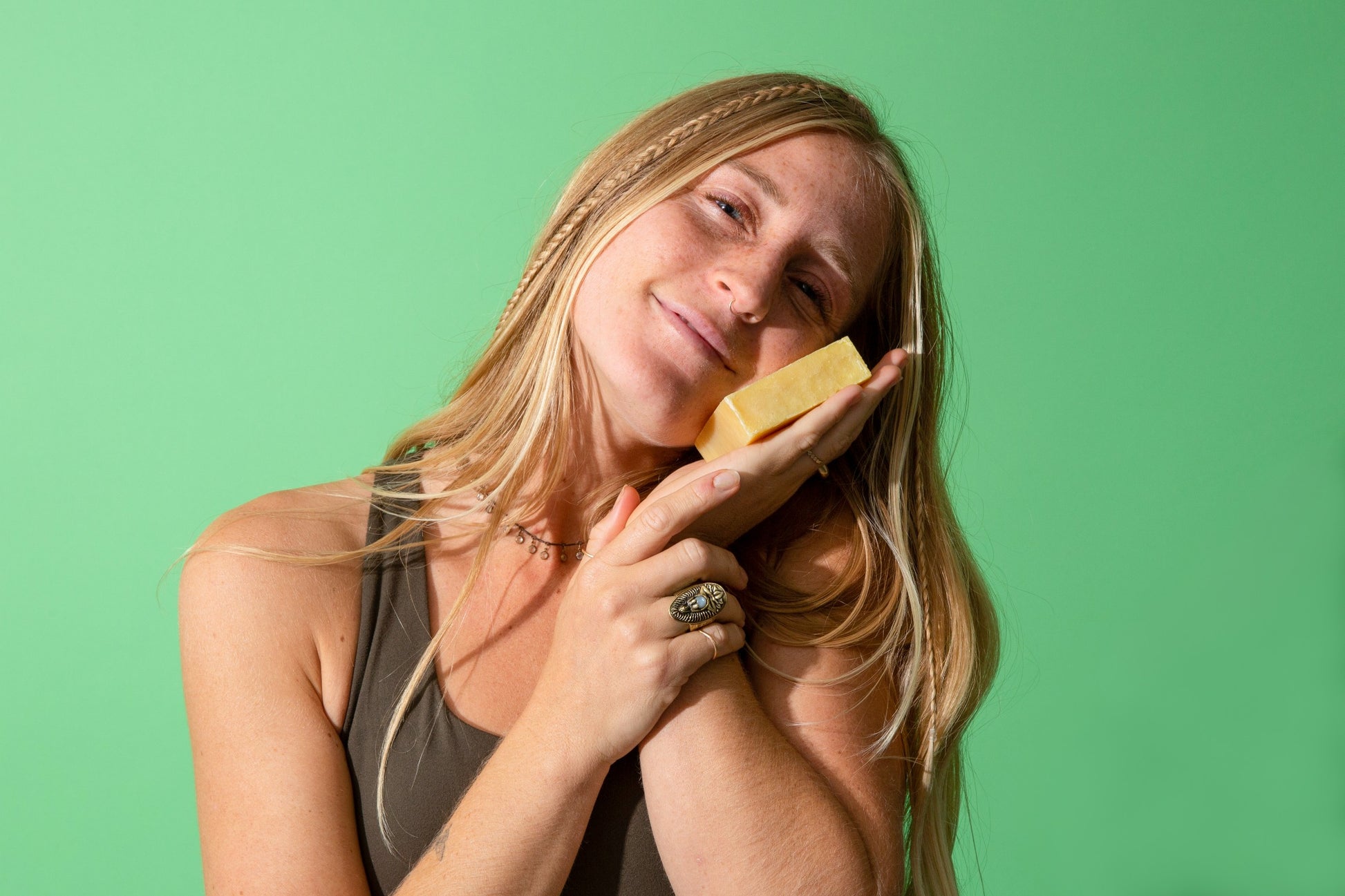 Tori placing Canary Citrus Bar Soap against her cheek